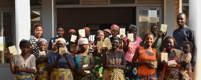 a group of ladies hold up their health cards happily