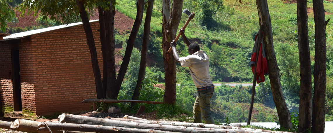 a lone man chops wood with an axe