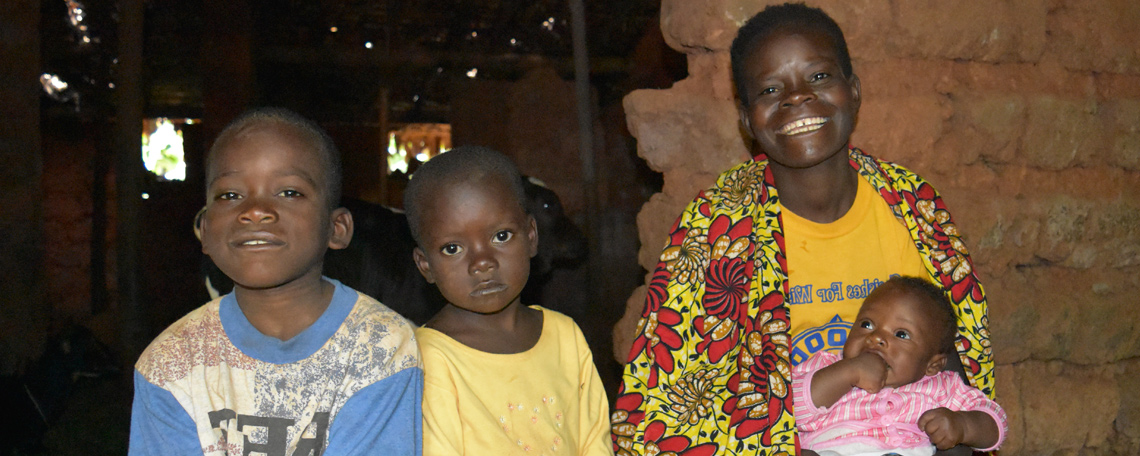 specoise smiles with her three young children in their home