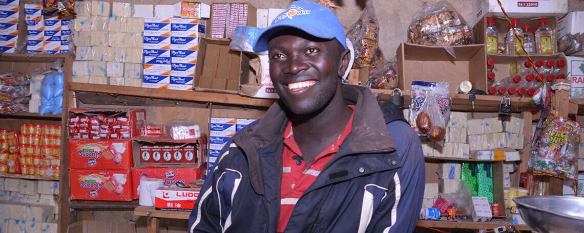 innocent poses inside his shop