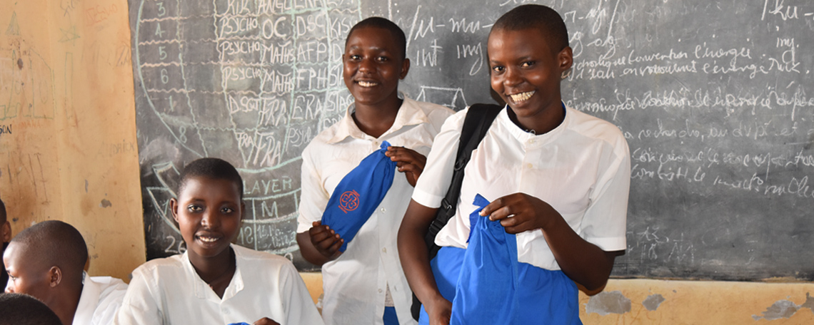 sanitary pads thank you Burundian schoolgirls holding new sanitary pad packs