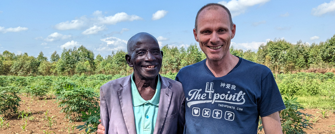 Simon Guillebaud with 83-year-old Pastor Isaac smiling in front of the land for the retirement home.