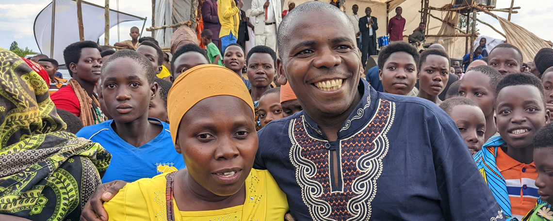 Anastasia and Isaiah smile for a photo together in the midst of a crowd at a UCCD gospel rally.