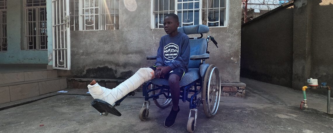 Issa sits in his wheelchair with a broken leg-new generation Burundi